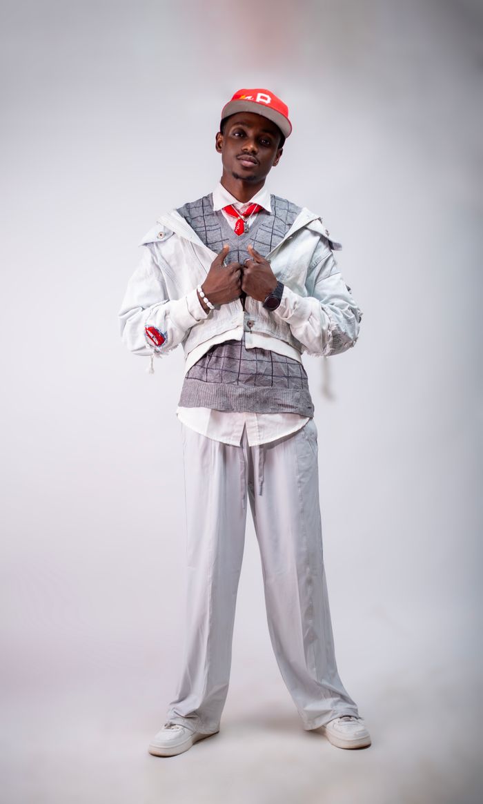 Mastering the First Impression: Your intriguing post title goes here Stylish young adult in modern white outfit posing confidently indoors.